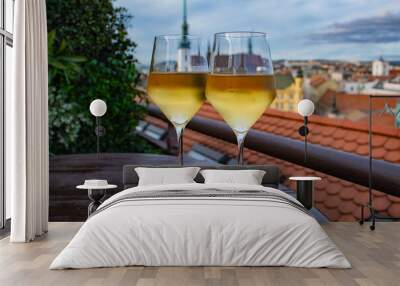 Glasses of white wine on a table overlooking the Czech city at night Wall mural