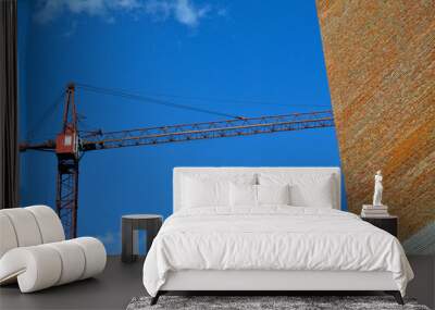 Tower crane on a background of blue sky Wall mural