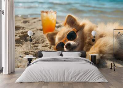 A red spitz dog in sunglasses lies on a sandy beach next to a fruit cocktail. Sunbathing and relaxing on tropical island. Wall mural