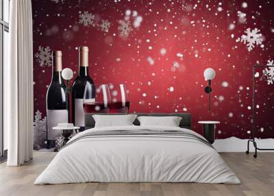 Two bottles and glasses of red wine on a New Year's snowy background with falling decorative snowflakes. Free space for product placement or advertising text. Wall mural