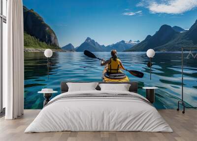 View from the back of a girl in a canoe floating on the water among the fjords. Wall mural