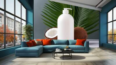 White cosmetic bottle of shampoo, soap or shower gel with a dispenser on the background of a broken coconut and tropical palm leaves. Wall mural