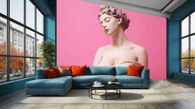 An exquisite female statue displayed against a soft pink backdrop. Created with generative AI tools Wall mural