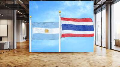 Argentina and Thailand two flags on flagpoles and blue sky Wall mural