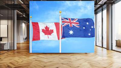 Canada and Australia  two flags on flagpoles and blue cloudy sky Wall mural