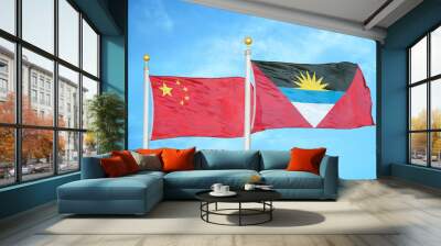 China and Antigua and Barbuda two flags on flagpoles and blue cloudy sky Wall mural