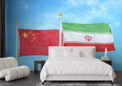 China and Iran two flags on flagpoles and blue cloudy sky Wall mural