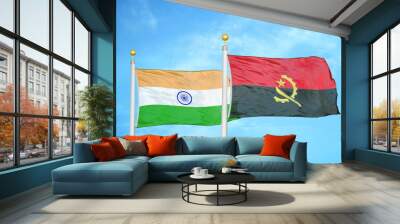 India and Angola two flags on flagpoles and blue cloudy sky Wall mural