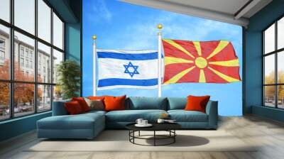 Israel and North Macedonia two flags on flagpoles and blue cloudy sky Wall mural