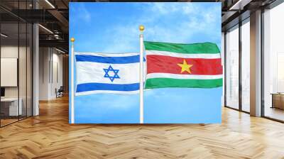 Israel and Suriname two flags on flagpoles and blue cloudy sky Wall mural