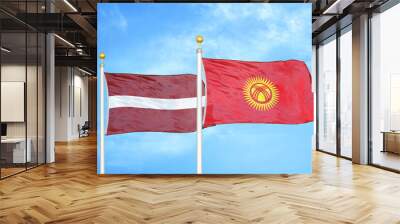 Latvia and Kyrgyzstan two flags on flagpoles and blue sky Wall mural