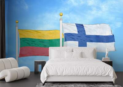 Lithuania and Finland two flags on flagpoles and blue sky Wall mural