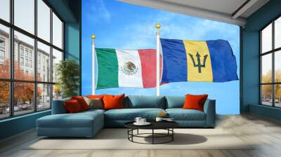 Mexico and Barbados  two flags on flagpoles and blue cloudy sky Wall mural