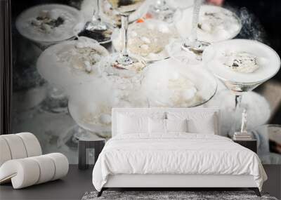 Pyramid with champagne glasses with steam of dry ice. Wall mural