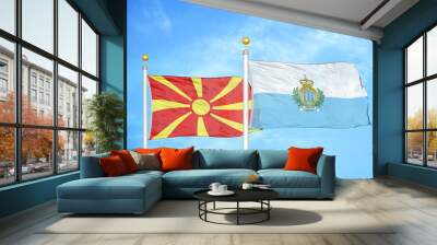 North Macedonia and San Marino two flags on flagpoles and blue sky Wall mural