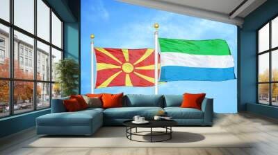 North Macedonia and Sierra Leone two flags on flagpoles and blue sky Wall mural