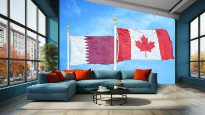 Qatar and Canada  two flags on flagpoles and blue cloudy sky Wall mural