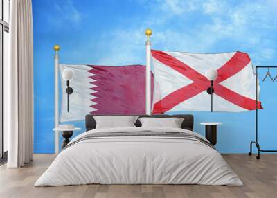 Qatar and Northern Ireland two flags on flagpoles and blue cloudy sky Wall mural