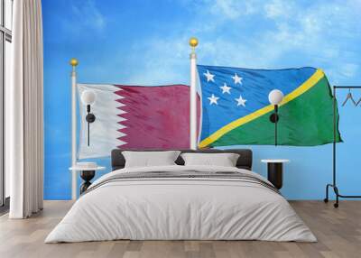 Qatar and Solomon Islands two flags on flagpoles and blue cloudy sky Wall mural