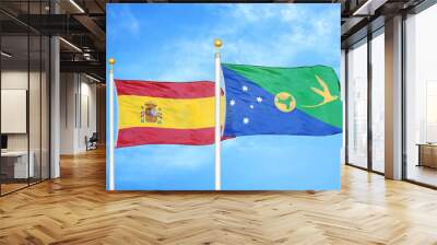 Spain and Christmas Island two flags on flagpoles and blue cloudy sky Wall mural