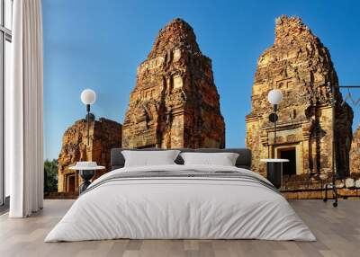 Three tall brick towers under a blue cloudless sky, the Pre Rup temple complex in Cambodia, Khmer architecture. Wall mural