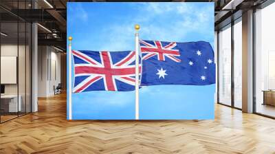 United Kingdom and Australia two flags on flagpoles and blue cloudy sky Wall mural