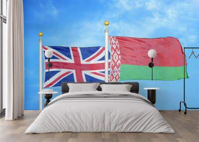 United Kingdom and Belarus two flags on flagpoles and blue cloudy sky Wall mural