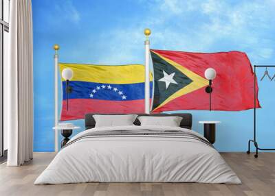 Venezuela and Timor-Leste East Timor two flags on flagpoles and blue sky Wall mural