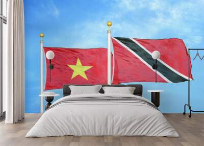 Vietnam and Trinidad and Tobago two flags on flagpoles and blue sky Wall mural