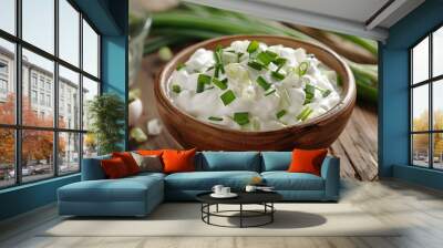 Bowl of tasty sour cream with green onion on table, closeup Wall mural