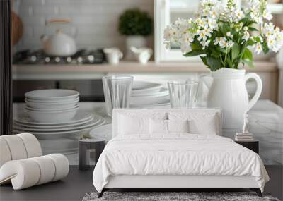 Clean plates, glasses, butter dish and floral decor on white marble table in kitchen Wall mural