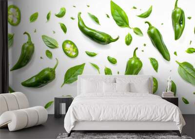 Flying green jalapeno peppers and fresh basil leaves on white background Wall mural