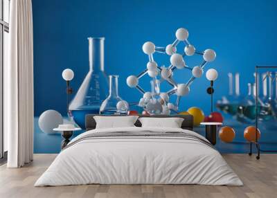 Laboratory glassware and molecule model on blue background Wall mural