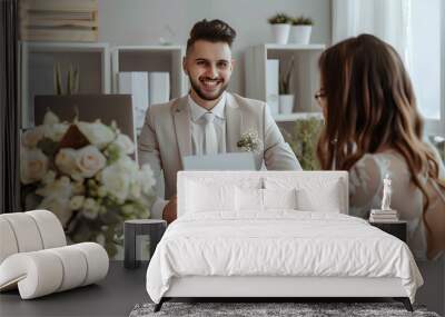 Male wedding planner working with couple in office Wall mural