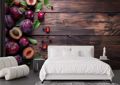 Ripe plums on wooden background Wall mural