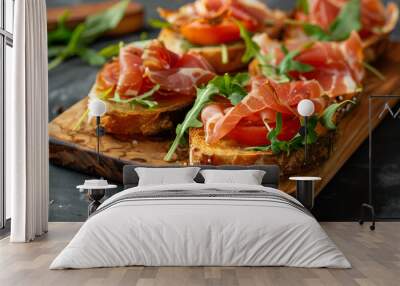 Tasty bruschetta with prosciutto, arugula, cheese and tomato on wooden board Wall mural