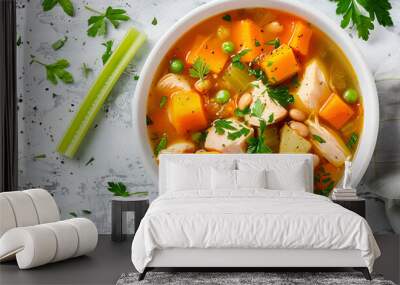 Tomato chicken soup with pumpkin, beans and celery in white bowl. Top view Wall mural