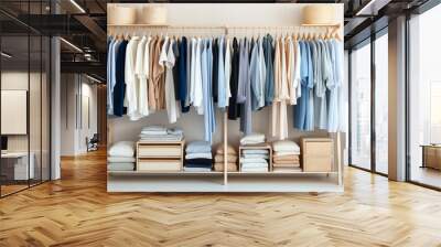 white, beige and blue clothes lay on shelves and hang on wooden hangers in a large white wooden closet Wall mural