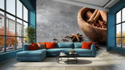 Wooden bowl with cinnamon sticks and anise on table Wall mural