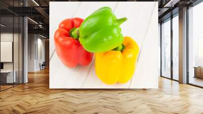 Heap of red yellow and green fresh whole raw pepper on old white rustic planks Wall mural