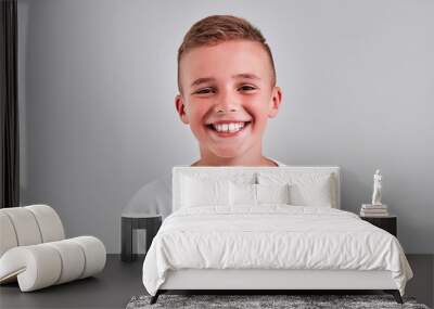 Cute boy on a gray background Wall mural