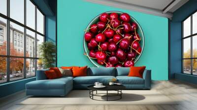 Fresh cherries in a bowl on green background. Healthy food concept Wall mural