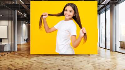 Happy teenager portrait. Emotional portrait of caucasian teenager child girl isolated on studio yellow background. Smiling girl. Wall mural