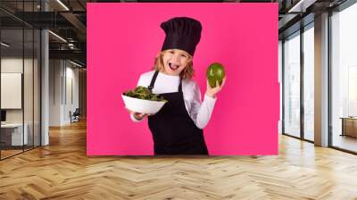 Kid cook with avocado and vegetable. Chef kid preparing healthy food. Portrait of child with chef hats. Wall mural