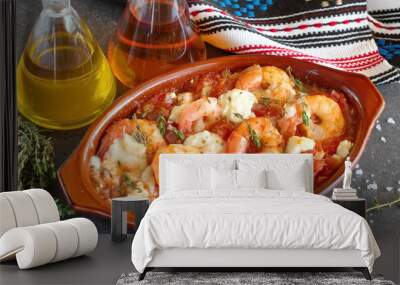 Oven backed prawns with feta, tomato, paprika, thyme in a traditional ceramic form on a abstract background. Healthy eating concept. Mediterranian lifestyle. Wall mural