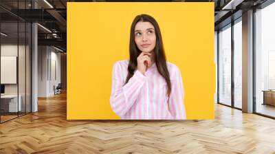 Portrait of young woman thinking, looking up empty space. Thoughtful serious model in studio looking away. Girl thought choose decide solve problems. Wall mural