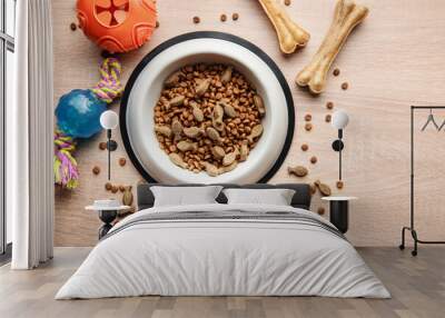 A bowl with dog food, dog treats and toys on a wooden floor. Wall mural