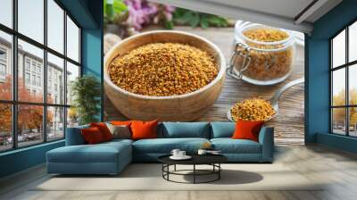 Healthy bee pollen grains.  Bee pollen on a bowl and acacia flowers. Wall mural