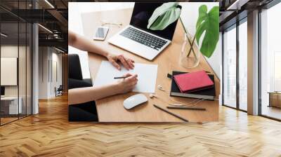 Young girl working at home office Wall mural