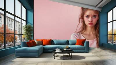 Sadly disgusted young woman isolated pink background with copy space Wall mural